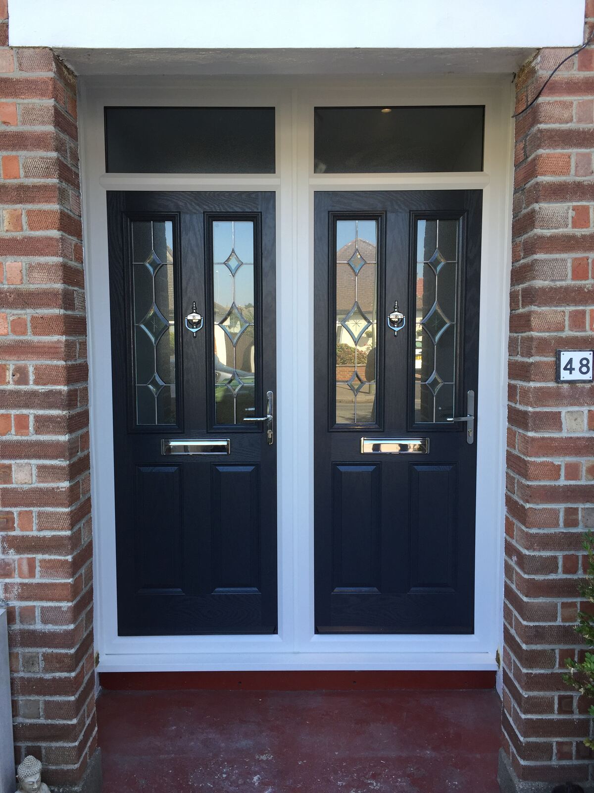 Black composite double doors with diamond glazing